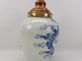 an image of a blue and white vase with a gold lid