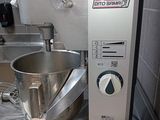 a silver mixer sitting on a counter in a kitchen