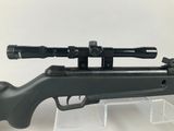 a close up of a rifle with a scope on it