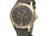 an image of a gold wrist watch with a black dial