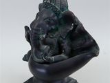 statue of an elephant in a boat on a white background