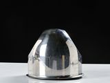 a silver dome on a white table with a black background