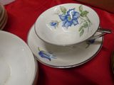 a red table cloth with plates and bowls on it
