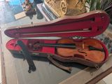 a violin and a violin case sitting on a table