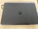 hp laptop on a table with power cord attached to it