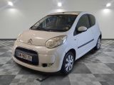 a picture of a small white car parked in a garage