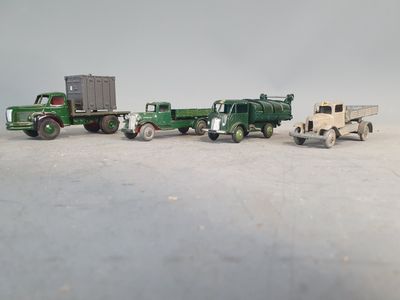several toy trucks are lined up in a row on a white surface