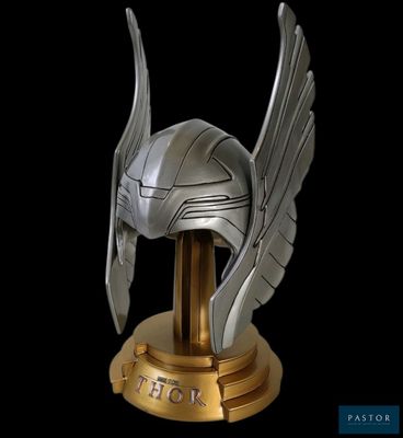 a helmet with wings on top of a gold pedestal