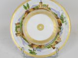 a close up of a plate on a stand on a white surface