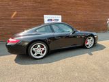 a picture of a black porsche parked in front of a building