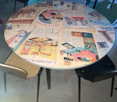 a round table made out of newspapers on the floor