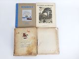 three books sitting on top of each other on a white surface