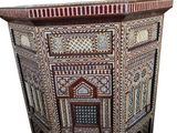 an image of a side table made of wood and decorated with intricate designs