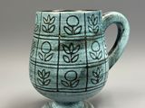 a close up of a cup with a pattern on it