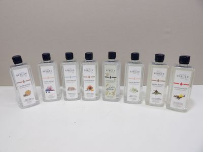 six bottles of perfume sitting on top of a white table