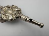 a silver object with a lion head on it