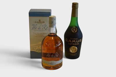 two bottles of alcohol and a box of wine on a white surface