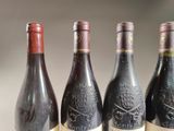 three bottles of wine are lined up on a table