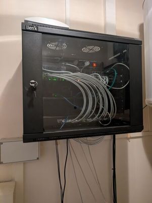 a black cabinet with wires on it in a room