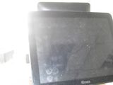 a computer monitor sitting on a desk with a remote control
