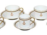 six cups and saucers with gold trimmings on them