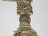 a statue of an eagle on a pedestal with a bird on it