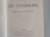 an open book on a table with a picture of the title of les chansonss