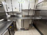 a kitchen with stainless steel counter tops and stainless steel cabinets