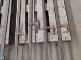 several pieces of wood sit on top of a concrete floor