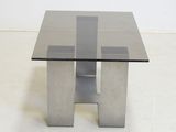 an image of a glass and steel coffee table on a white floor