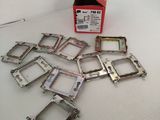 a box of assorted metal parts on a white surface