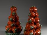 pair of red and green ceramic tomatoes on green trays