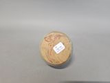 a close up of a small wooden object on a table