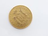 a close up of a gold coin on a white surface