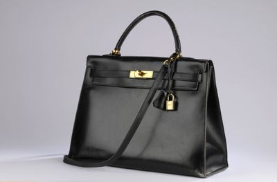 a black leather handbag on a white surface