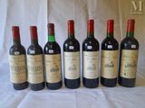 six bottles of wine are lined up on a table