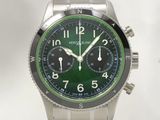 un gros plan d'une montre au cadran vert