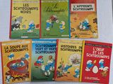 Six livres sur les Schtroumpfs sont alignés sur une table