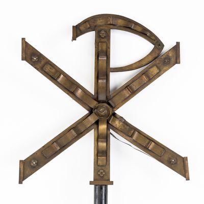 a large metal object with a cross on top of it