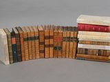 several old books stacked on top of each other on a table