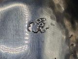 a close up of a metal bowl with a metal lid