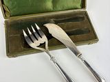 two forks and a spoon in a case