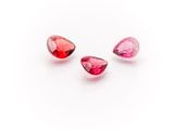 three pink tourmaline gems on a white background