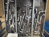 many wrenches in a metal case with a note on it