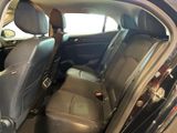 the back seats of a car with a dog sitting in the passenger seat