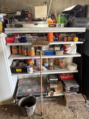 a refrigerator with many items on it in a garage
