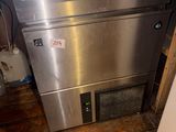 a stainless steel dishwasher in the corner of a kitchen