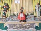 a box with a picture of a man and a woman playing a pipe organ
