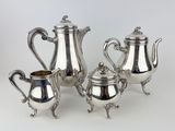 three pieces of silver tea and coffee set on a white background