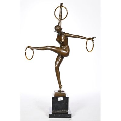 a bronze statue of a woman with a hoop on her head